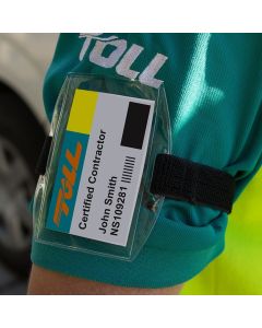 A clear armband strap displaying work identification. It is being worn by a contractor while working.