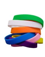 Promotional in stock silicone wristbands for events and trade shows stacked together in bulk from Custom Lanyards Canada.